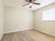 Bedroom with ceiling fan and wood-look flooring at 6042 Bolling Dr, Orlando, FL 32808