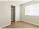 Well-lit bedroom featuring wood-look floors and a window providing natural light at 6042 Bolling Dr, Orlando, FL 32808