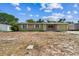 Inviting single-Gathering home featuring stone facade and an attached one car garage, full view of the front yard at 6042 Bolling Dr, Orlando, FL 32808