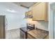 Eat-in kitchen with stainless steel refrigerator, black stove, updated countertops and honey toned wood cabinets at 6042 Bolling Dr, Orlando, FL 32808