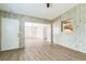 Open living area with wood-paneled walls and wood-look flooring, offering a view into the eat-in kitchen at 6042 Bolling Dr, Orlando, FL 32808