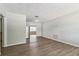 Clean, bright living room with wood-look floors and neutral paint, open to the kitchen and additional living space at 6042 Bolling Dr, Orlando, FL 32808