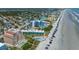 An aerial view of a blue apartment building with swimming pools, parking, and proximity to the beach at 611 S Atlantic Ave # 4212, New Smyrna Beach, FL 32169
