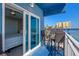 Balcony seating with peek to bedroom and view of pool and palm trees at 611 S Atlantic Ave # 4212, New Smyrna Beach, FL 32169