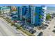 Blue and white condo exterior showcases a view of palm trees, balconies, and parking lot at 611 S Atlantic Ave # 4212, New Smyrna Beach, FL 32169