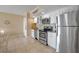Charming kitchen featuring stainless steel appliances, granite counters, and white cabinetry at 611 S Atlantic Ave # 4212, New Smyrna Beach, FL 32169