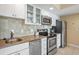 Well-equipped kitchen with stainless steel appliances, granite counters, and white cabinetry at 611 S Atlantic Ave # 4212, New Smyrna Beach, FL 32169