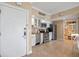 Well-lit condo kitchen featuring stainless steel appliances, white cabinetry, and tile flooring at 611 S Atlantic Ave # 4212, New Smyrna Beach, FL 32169
