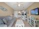 Open-concept living area with sofa, television, dining space, and open kitchen for a modern feel at 611 S Atlantic Ave # 4212, New Smyrna Beach, FL 32169