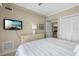 Relaxing bedroom with a beach-themed decor, featuring a TV and ample closet space at 611 S Atlantic Ave # 4212, New Smyrna Beach, FL 32169