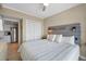 Comfortable main bedroom with a rustic headboard and view to kitchen at 611 S Atlantic Ave # 4212, New Smyrna Beach, FL 32169