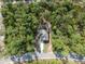 This aerial view shows the home nestled in a private, wooded lot at 6730 Orlando Drive, Indian Lake Estates, FL 33855