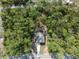 This aerial view shows the home nestled in a private, wooded lot at 6730 Orlando Drive, Indian Lake Estates, FL 33855