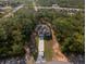 This aerial view shows the home nestled in a private, wooded lot at 6730 Orlando Drive, Indian Lake Estates, FL 33855