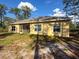 This home features an enclosed porch overlooking the backyard at 6730 Orlando Drive, Indian Lake Estates, FL 33855