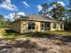 This home features an enclosed porch overlooking the backyard at 6730 Orlando Drive, Indian Lake Estates, FL 33855