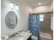 This bathroom has gray tiled shower and a granite countertop sink at 6730 Orlando Drive, Indian Lake Estates, FL 33855