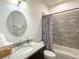 The bathroom offers a granite vanity and tiled shower with tub at 6730 Orlando Drive, Indian Lake Estates, FL 33855