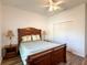 This bedroom has wood-look floors and a convenient closet at 6730 Orlando Drive, Indian Lake Estates, FL 33855