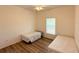 This bedroom showcases wood-look flooring and a bright window at 6730 Orlando Drive, Indian Lake Estates, FL 33855