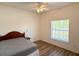This bedroom features wood-look flooring and a ceiling fan at 6730 Orlando Drive, Indian Lake Estates, FL 33855