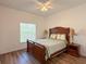 This spacious bedroom offers natural light and wood-look flooring at 6730 Orlando Drive, Indian Lake Estates, FL 33855