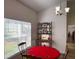 Bright breakfast nook featuring a red poker table and ornate furnishings near a sunlit window at 6730 Orlando Drive, Indian Lake Estates, FL 33855