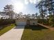 Charming single-story home featuring a well-manicured lawn and a long driveway at 6730 Orlando Drive, Indian Lake Estates, FL 33855