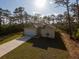 Charming single-story home featuring a well-manicured lawn and a long driveway at 6730 Orlando Drive, Indian Lake Estates, FL 33855
