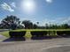 A sprawling green golf course with manicured shrubbery under a sunny blue sky at 6730 Orlando Drive, Indian Lake Estates, FL 33855