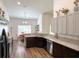 Spacious kitchen with dark wood cabinets, stainless steel appliances and a breakfast nook bathed in natural light at 6730 Orlando Drive, Indian Lake Estates, FL 33855