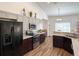 Updated kitchen with granite countertops, stainless appliances, and modern two-tone cabinetry at 6730 Orlando Drive, Indian Lake Estates, FL 33855