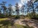 The property features mature trees and a large lot at 6730 Orlando Drive, Indian Lake Estates, FL 33855