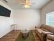 The living room boasts wood-look flooring and a neutral color palette at 6730 Orlando Drive, Indian Lake Estates, FL 33855