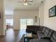 Open living room featuring wood floors, a comfortable sectional, and sliding glass doors at 6730 Orlando Drive, Indian Lake Estates, FL 33855