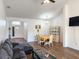 Bright, open-concept living space with wood floors connecting the living room and dining area at 6730 Orlando Drive, Indian Lake Estates, FL 33855
