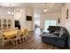 Open-concept living space with wood floors, seamlessly connecting living, dining, and kitchen areas at 6730 Orlando Drive, Indian Lake Estates, FL 33855