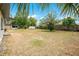 Large backyard featuring dry grass and shed at 6820 Ambassador Dr, Orlando, FL 32818