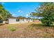 View of the home's exterior showing the lush backyard and white exterior paint at 6820 Ambassador Dr, Orlando, FL 32818