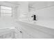 Bright white bathroom featuring tile walls, modern fixtures, and vanity at 6820 Ambassador Dr, Orlando, FL 32818