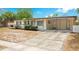 Charming single story home featuring updated black shutters, a large driveway, and covered porch at 6820 Ambassador Dr, Orlando, FL 32818