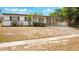 Charming home featuring a covered porch and a large front yard at 6820 Ambassador Dr, Orlando, FL 32818