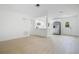 Bright and open living room with modern wood-look floors adjacent to the white kitchen at 6820 Ambassador Dr, Orlando, FL 32818