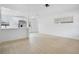 Bright and open living room with modern wood-look floors adjacent to the white kitchen at 6820 Ambassador Dr, Orlando, FL 32818