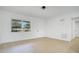 Bright living area with wood-look flooring, a large window, and white walls at 6820 Ambassador Dr, Orlando, FL 32818