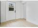 Bright mud room with wood-look flooring, white walls, and a windowed door at 6820 Ambassador Dr, Orlando, FL 32818