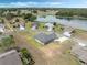 Aerial view of a home in a well-planned community with a scenic lake and lush landscaping at 72 Fairway Cir, Umatilla, FL 32784