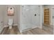 Bathroom shows glass shower with marble tiling, adjacent to toilet and wall art at 72 Fairway Cir, Umatilla, FL 32784