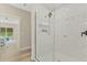 Bathroom features a glass enclosed shower with marble tiling and modern fixtures at 72 Fairway Cir, Umatilla, FL 32784