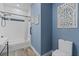 Bathroom features a sink, toilet, and tub with shower and blue accent wall at 72 Fairway Cir, Umatilla, FL 32784
